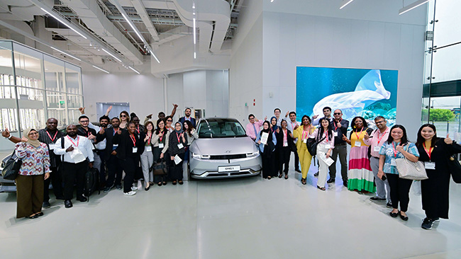 The group concluded their HMGICS discovery tour with an iconic photo featuring the Ioniq 5. Photo credit: Ministry of Foreign Affairs, Singapore