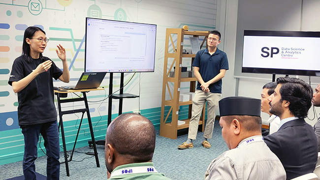 Participants experiencing hands-on AI applications at Singapore Polytechnic's Data Science & Analytics Centre, bridging theoretical knowledge with practical implementation.