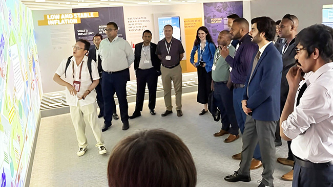 Participants gaining insights into Singapore's innovative fintech ecosystem during their immersive tour of the MAS Gallery, a showcase of regulatory excellence.