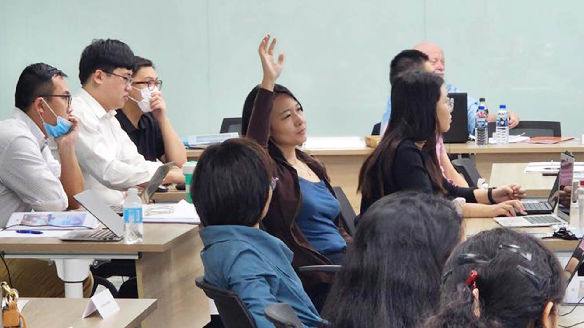 Participants actively engaging in the lecture, taking turns to ask insightful questions and fostering a collaborative learning environment